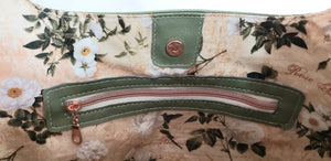 Interior of bag showing magnetic snap and zippered pocket